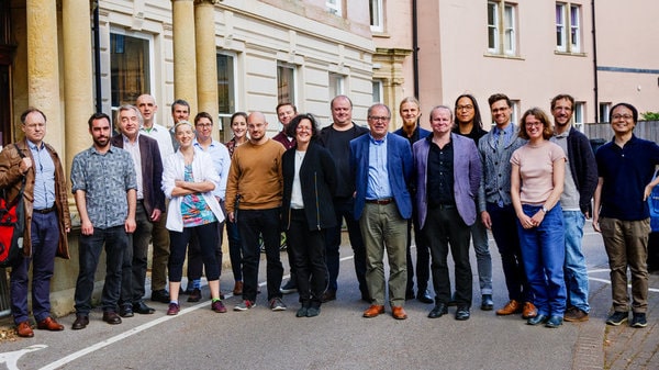 Members of the philosophy department – around 20 men and women of diverse races – stood outside the department building.